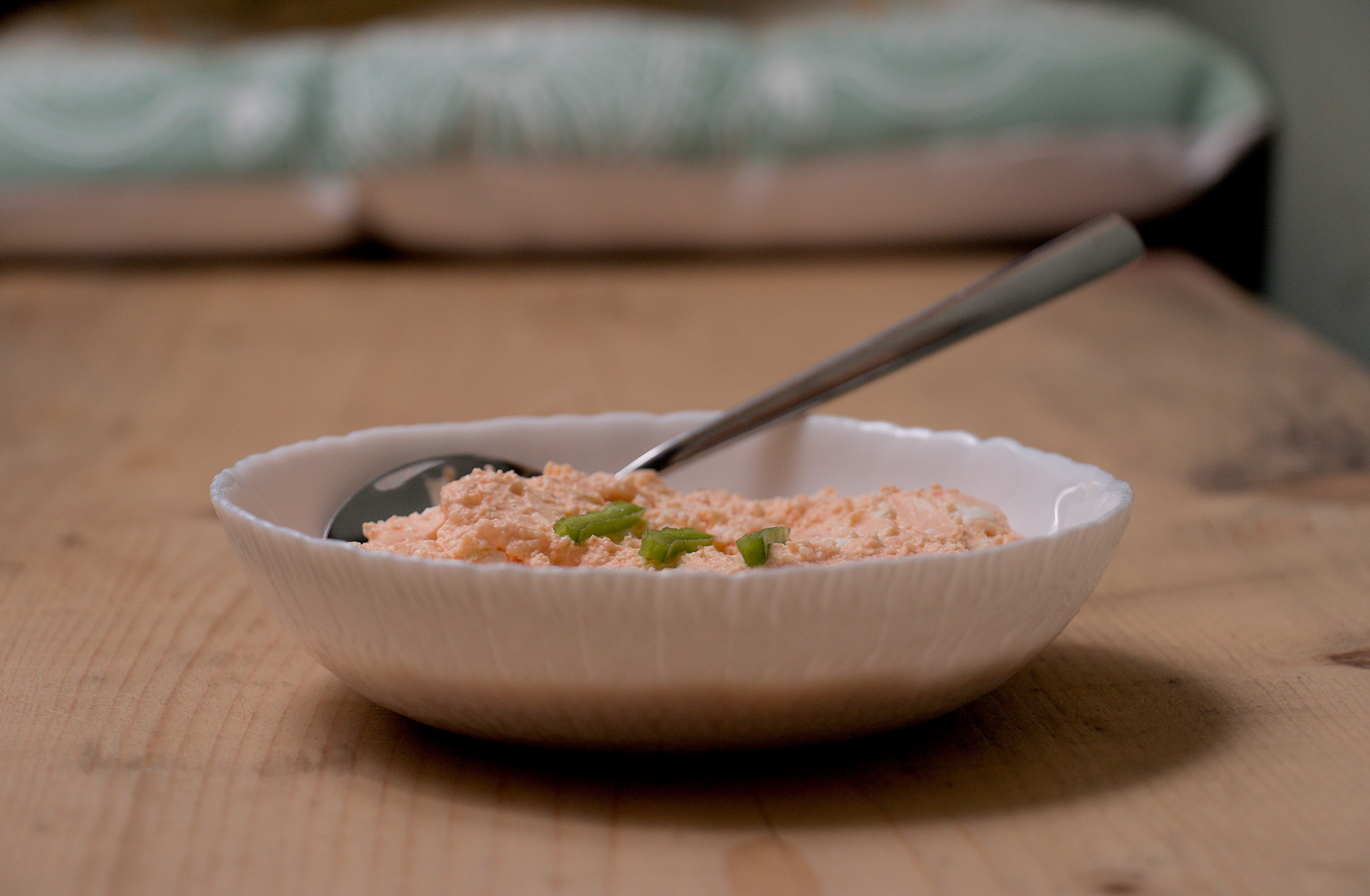 Close up, eye level view of a plate with a peinirli topped with two fried eggs.