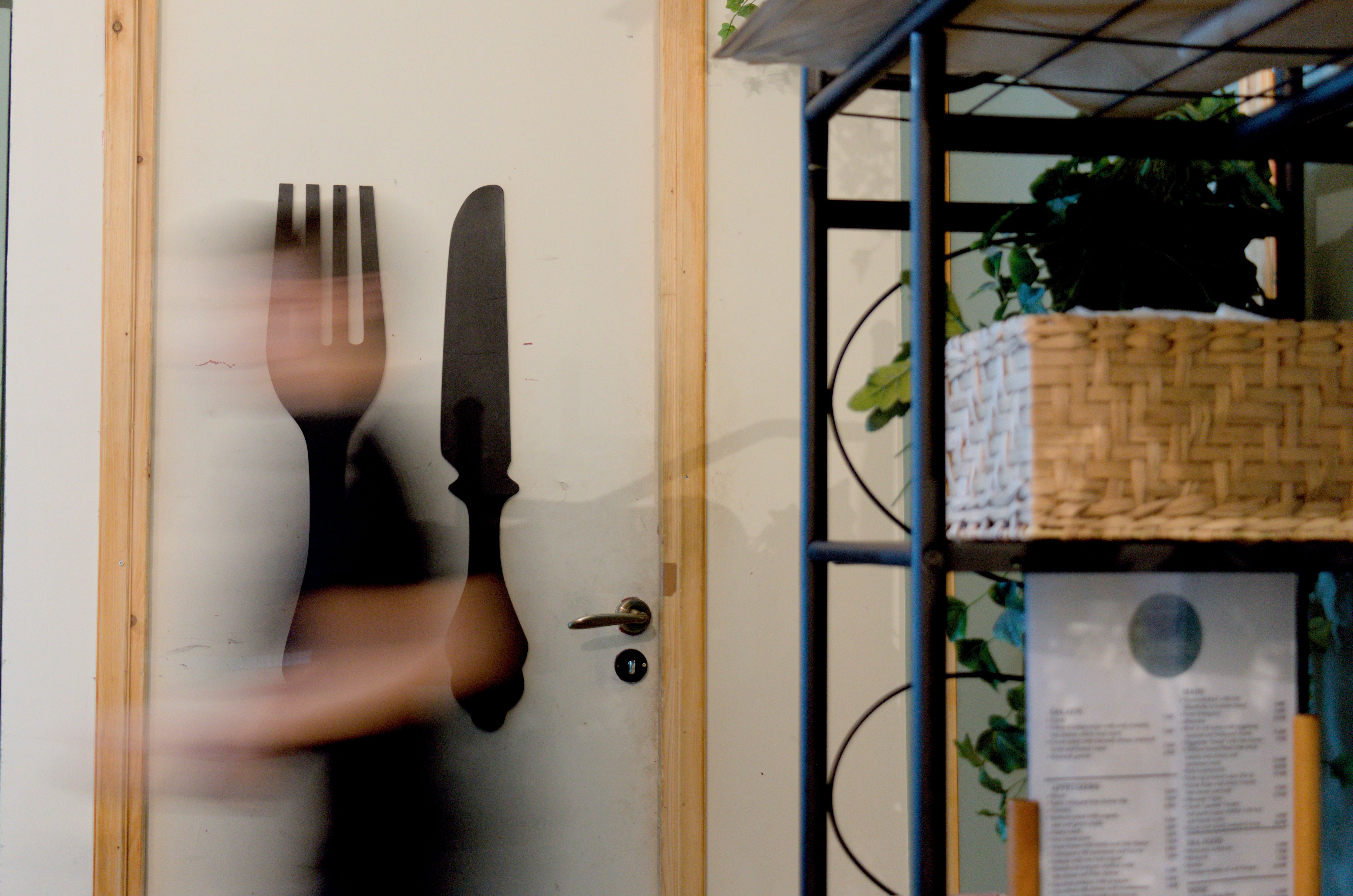 Close up, eye level view of a plate with a peinirli topped with two fried eggs.